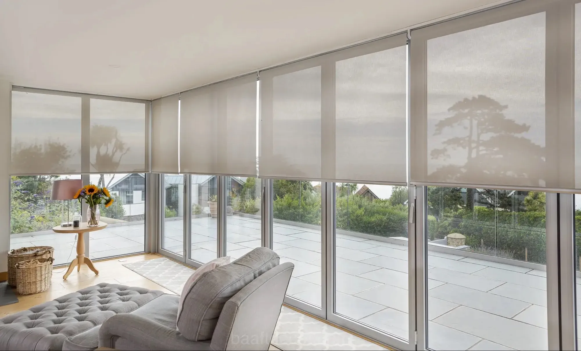 Living room with roller blinds on floor-to-ceiling windows