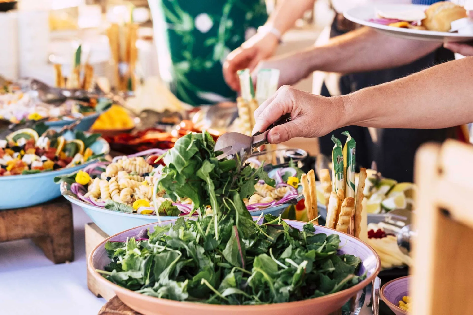 Guests serving salad at a buffet